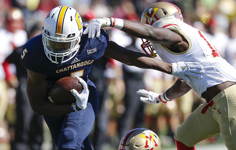 UTC wide receiver Bingo Morton stiff-arms VMI defensive back Greg Sanders as he rushes for a touchdown during the Mocs' home football game against the VMI Keydets at Finely Stadium on Saturday, Oct. 22, 2016, in Chattanooga, Tenn.