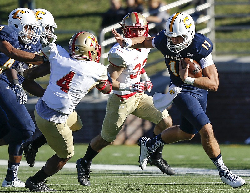 UTC quarterback Tyler Roberson (17) stiff-arms VMI defensive back Uzoma Kpaduwa during the Mocs' home football game against the VMI Keydets at Finely Stadium on Saturday, Oct. 22, 2016, in Chattanooga, Tenn.