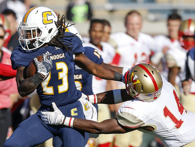 UTC running back Richardre Bagley stiff-arms VMI defensive back Greg Sanders  on a touchdown run during the Mocs' home football game against the VMI Keydets at Finely Stadium on Saturday, Oct. 22, 2016, in Chattanooga, Tenn.