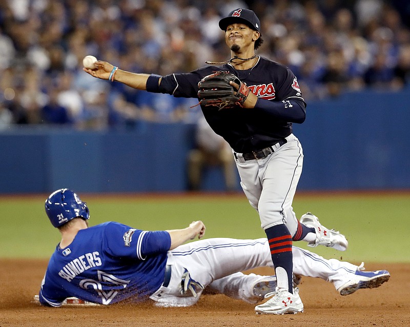 
              FILE- In this Tuesday Oct. 18, 2016, file photo, Cleveland Indians shortstop Francisco Lindor, right, forces Toronto Blue Jays' Michael Saunders out at second, but, fails to throws Ezequiel Carrera out at first during the second inning in Game 4 of baseball's American League Championship Series in Toronto.  A leader in the clubhouse and on the field, Cleveland's 22-years-old exuberant shortstop has blossomed in this postseason will now showcase his immense talents in the World Series. (Mark Blinch/The Canadian Press via AP, File)
            