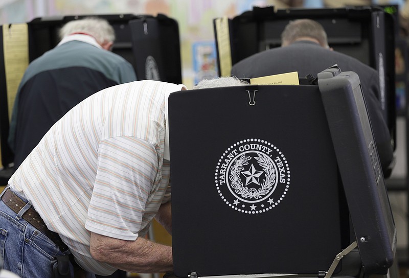 In this March 1, 2016 file photo, voters make their choice in the ballot booth during primary election day at Sherrod Elementary School in Arlington, Texas. Officials in Texas, Oklahoma and Louisiana say they've denied a request by Russian officials to be present at polling stations during the November general election. The U.S. State Department's spokesman says Russia hasn't participated in an international mission to observe elections, so its effort to do so on the state level represents "nothing more than a PR stunt." (AP Photo/LM Otero, File)