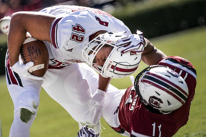 South Carolina linebacker T.J. Holloman (11) tackles Massachusetts fullback John Robinson-Woodgett (42) during the first half of an NCAA college football game Saturday, Oct. 22, 2016, in Columbia, S.C. (AP Photo/Sean Rayford)