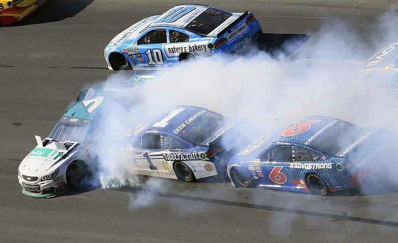 
              Kasey Kahne (1) turns sideways as Jamie McMurray (1) and Trevor Bayne (6) wreck at the NASCAR Sprint Cup Series auto race auto race at Talladega Superspeedway, Sunday, Oct. 23, 2016, in Talladega, Ala. (AP Photo/Dale Davis)
            