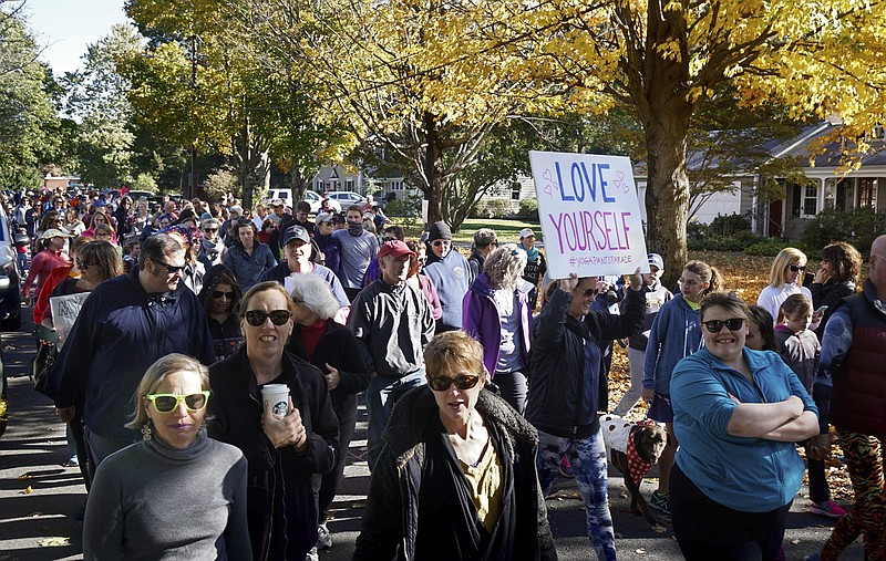 
              People march for "yoga pants parade" in Barrington, R.I., Sunday, Oct. 23, 2016. Hundreds of women, girls and other supporters proudly donned their yoga pants Sunday afternoon as they peacefully paraded around the Rhode Island neighborhood of a man who derided the attire as tacky and ridiculous. (Kris Craig/Providence Journal via AP)
            