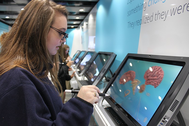 
              In this Tuesday, Oct. 18, 2016 photo, Catherine Wilhite, 14, dissects a virtual brain using 3-D virtual reality technology inside a zSpace Mobile Classroom in Jackson, Tenn. Roger Choate, co-owner of Learning Partners, which sells zSpace immersive 3-D virtual reality says, “It addresses many different learning styles that are tougher to address in a traditional classroom." (Katherine Burgess/The Jackson Sun via AP)
            