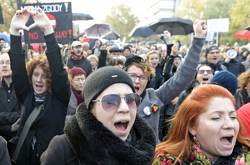 
              Protesters shout slogans during a rally in front of the parliament in Warsaw, Poland, Sunday, Oct. 23, 2016. Polish women again donned black and took to the streets on Sunday, launching another round of protests against efforts by the nation's conservative leaders to tighten Poland's already restrictive abortion law. (AP Photo/Alik Keplicz)
            