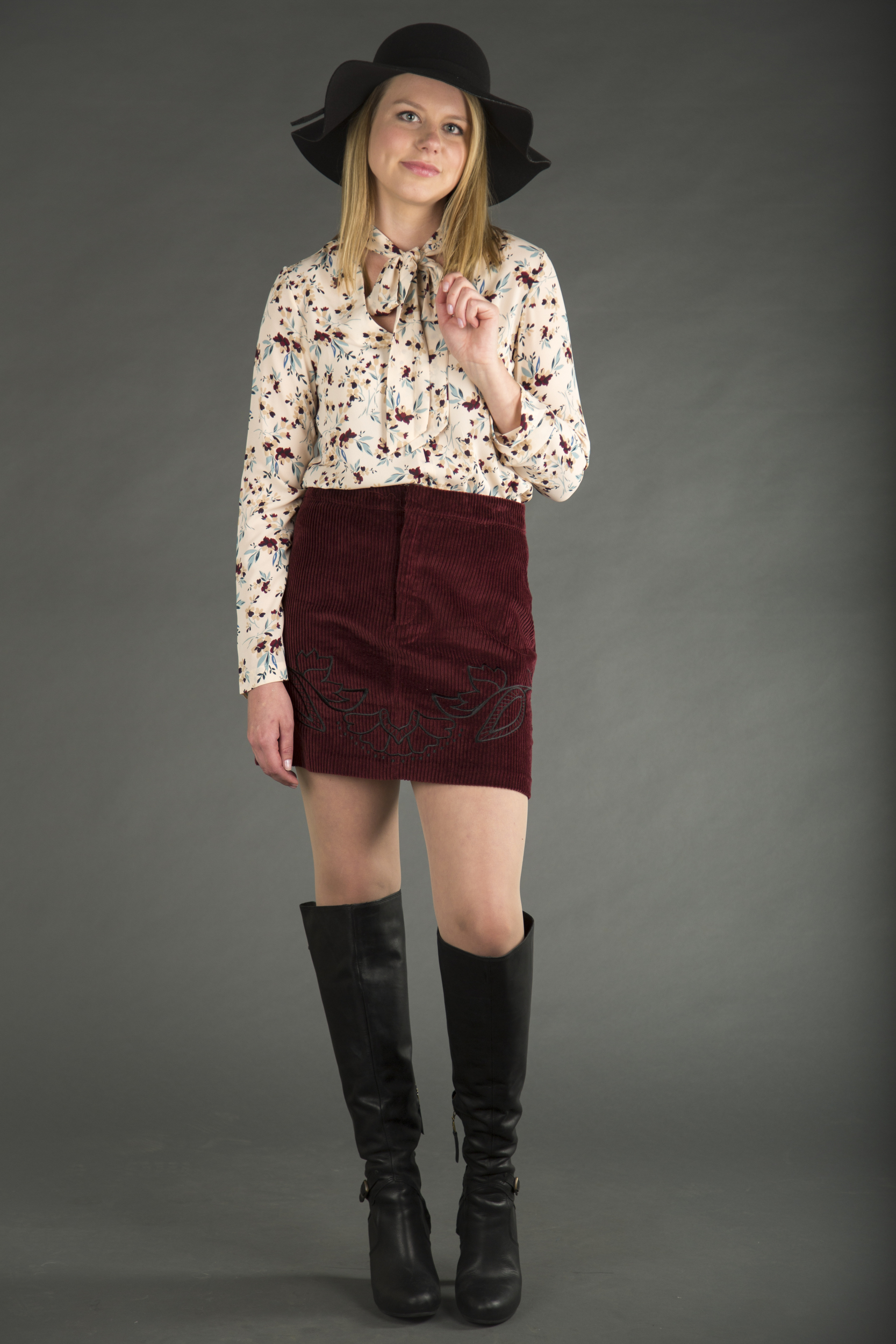 Bobeau tie-neck floral top and MinkPink corduroy skirt, both available at Merch Northshore. Black felt hat, available at Fab'rik. Ugg over the knee boots, available at Dillard's.