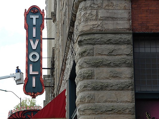 Travis Mills works to replace lights on the marquee outside the Tivoli Theatre.