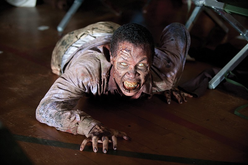 In this image released by AMC, a zombie appears in a scene from the second season of the AMC original series "The Walking Dead." Since its 2010 debut, the series has spawned a horde of supernatural/horror television shows.