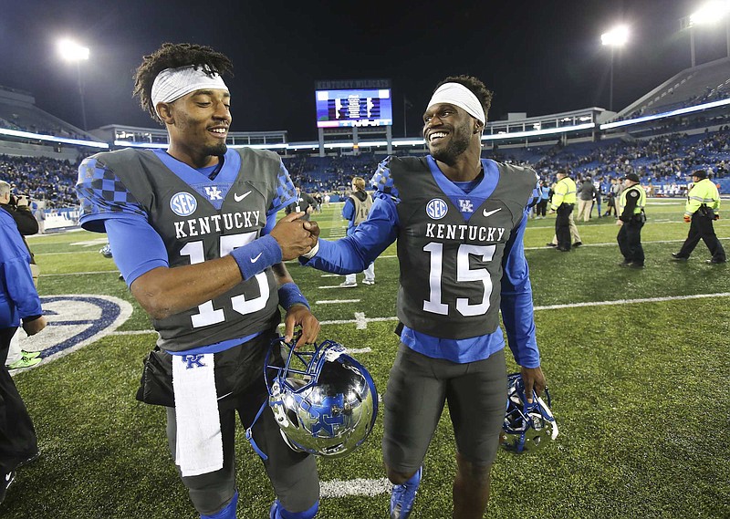 Kentucky's two players who wear No. 15, quarterback Stephen Johnson, left, and safety Marcus McWilson, celebrate after Saturday night's 40-38 win over Mississippi State.