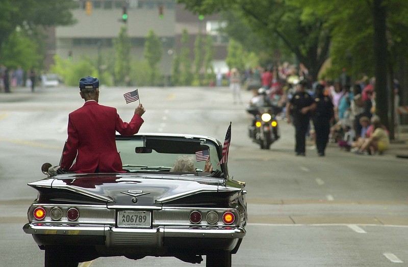 World War II veteran and Medal of Honor recipient Desmond Doss rides in a car past the grand stand on Market St. during an Armed Forces parade in downtown Chattanooga in 2002. Doss was awarded the Medal of Honor for his role in Okinawa as an Army medic.