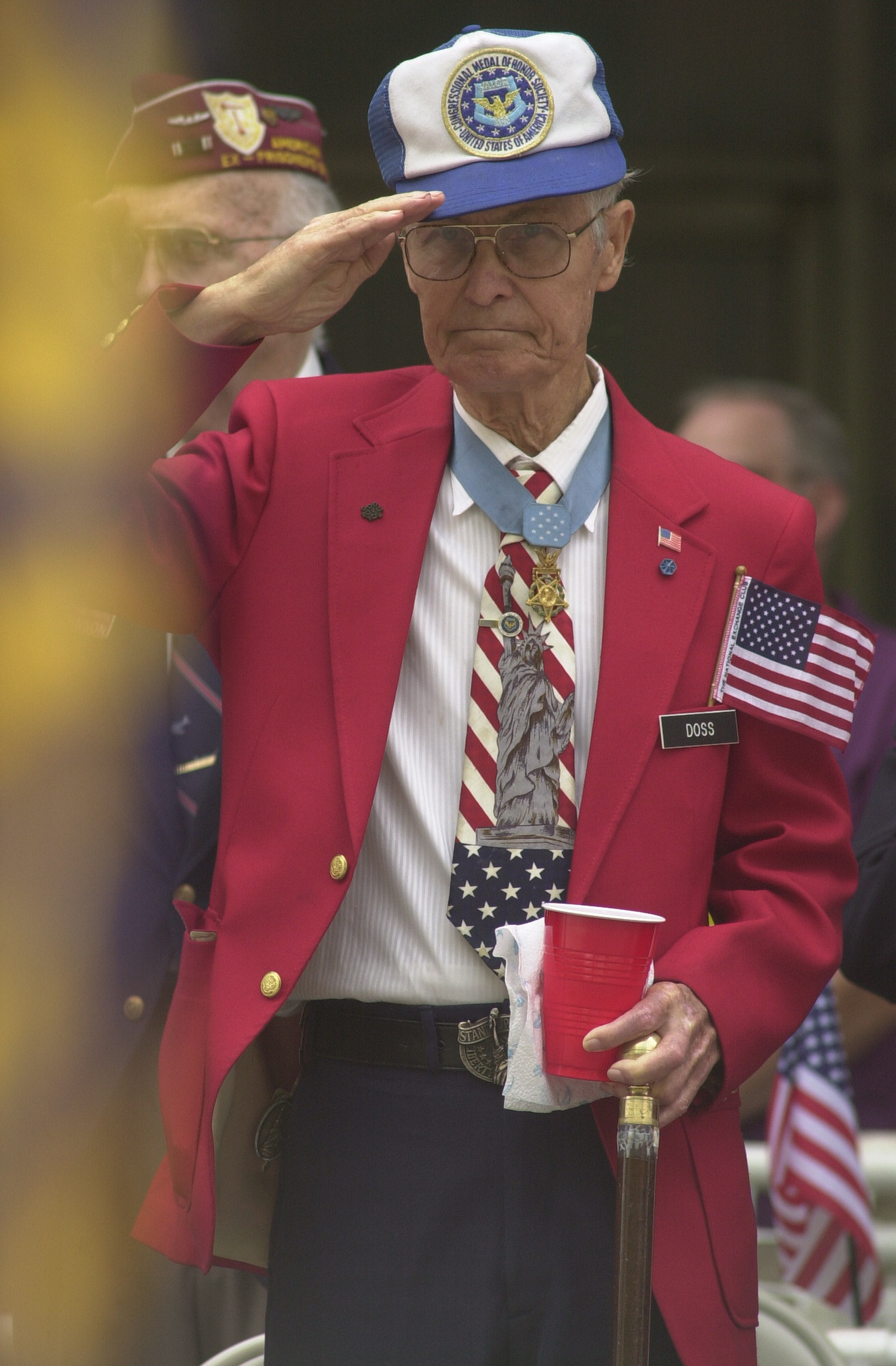 World War II veteran and Medal of Honor recipient Desmond Doss salutes the American flag from the grand stand on Market St. during the Armed Forces parade in downtown Chattanooga in 2002. Doss was awarded the Medal of Honor for his role in Okinawa as an Army medic.