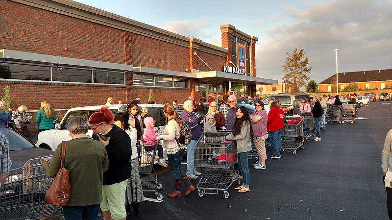 Shoppers line up outside the new Aldi grocery store Wednesday morning to get a look at the Ooltewah location.