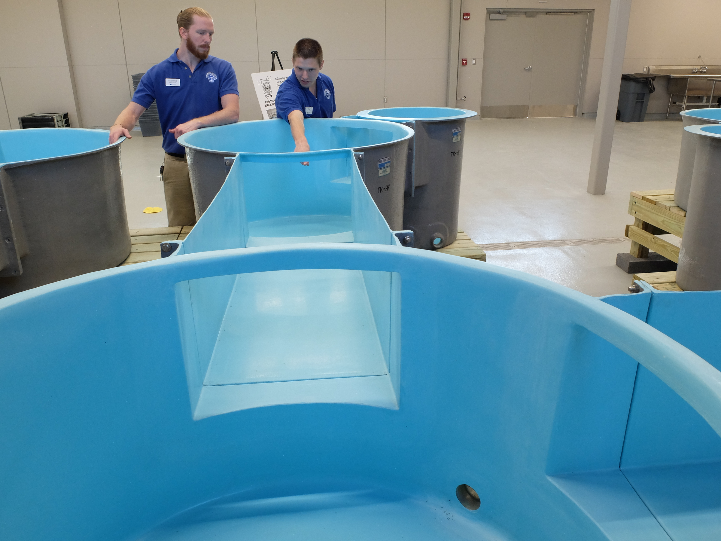 Maxwell Rupp, left, and Clay Raines talk about the propagation room tanks inside the newly built Tennessee Aquarium Conservation Institute on the Tennessee River near the Baylor School campus.