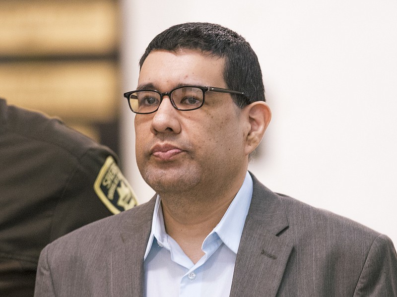 
              In this Sept. 27, 2016 photo, Anthony Garcia is led by deputies at the Douglas County Court in Omaha, Neb. Closing arguments are taking place Tuesday, Oct. 25, 2016, in his trial. Garcia, a former doctor, is accused of killing four people with ties to the Creighton medical school that fired him in 2001. (AP Photo/Nati Harnik)
            