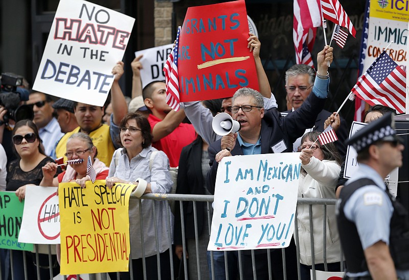 
              FILE - In this June 29, 2015, file photo, protesters gather across the street from a restaurant in Chicago before Republican presidential candidate Donald Trump spoke to members of the City Club of Chicago. When it comes to connecting with and motivating Hispanic voters, GOP candidates across the country face an exceptional obstacle: their own presidential nominee. Trump’s harsh words about immigrants in the country illegally and his vows to deport them and build a border wall have turned off many of the estimated 27 million Latinos eligible to vote. (AP Photo/Charles Rex Arbogast, File)
            