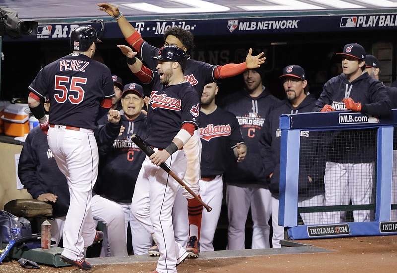 Cleveland Indians' Roberto Perez celebrates with teammates after hitting a three-run home run during the eighth inning of Game 1 of the Major League Baseball World Series against the Chicago Cubs Tuesday, Oct. 25, 2016, in Cleveland. (AP Photo/Gene J. Puskar)