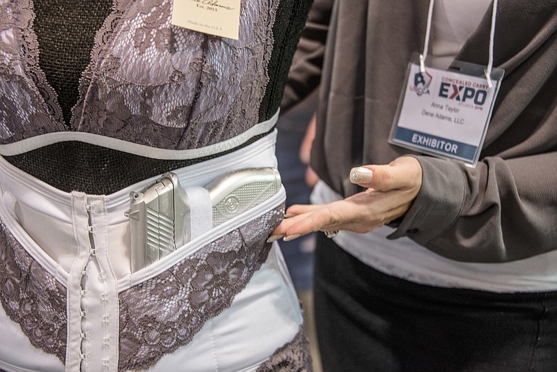 Anna Taylor, founder and CEO of Dene Adams in Atlanta, displays a corset that allows for the concealed carrying of a firearm. For decades, women have had few choices when it comes to the clothing they can wear to hide that they're carrying a firearm. Taylor's company makes clothing geared to women seeking to carry a firearm concealed. (AP Photo/Lisa Marie Pane)