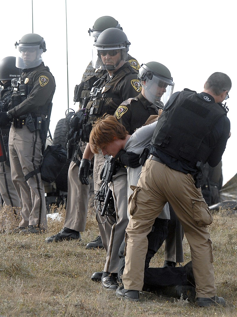 
              An unidentified Dakota Access Pipeline protester is arrested inside the Front Line Camp as law enforcement surround the camp to remove the protesters from the property and relocated to the overflow camp a few miles south of Highway 1806 in Morton County, N.D., Thursday, Oct. 27, 2016. (Mike McCleary/The Bismarck Tribune via AP)
            