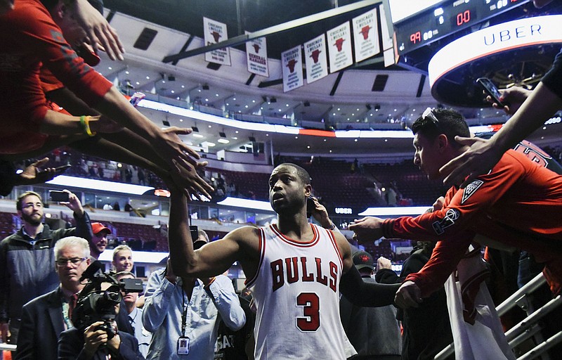 
              In his first game with the team, Chicago Bulls guard Dwyane Wade (3) greets fans after an NBA basketball game against the Boston Celtics Thursday, Oct. 27, 2016, in Chicago. The Chicago Bulls won 105-99. (AP Photo/Matt Marton)
            