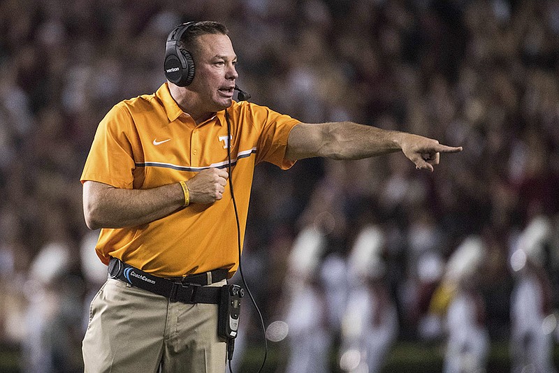 Tennessee head coach Butch Jones communicates with players during the first half of an NCAA college football game against South Carolina Saturday, Oct. 29, 2016, in Columbia, S.C. (AP Photo/Sean Rayford)