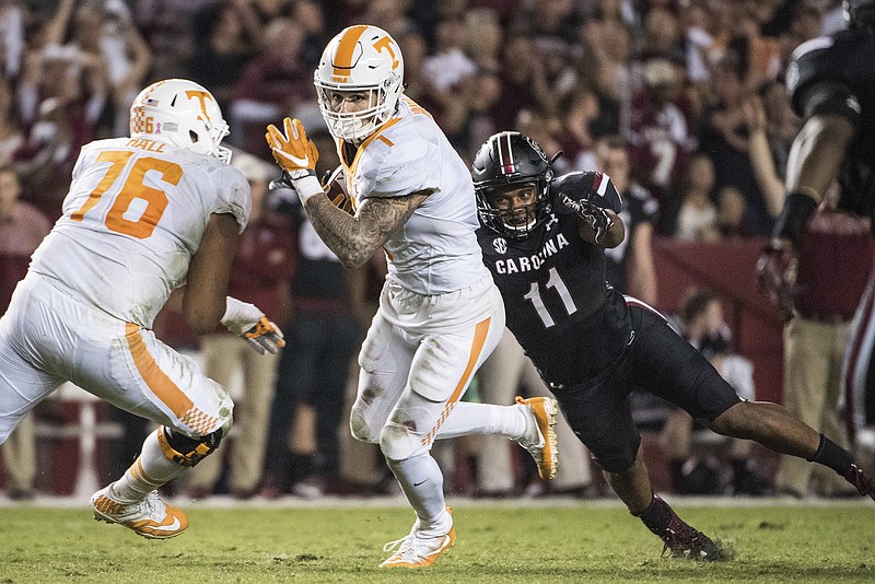 Tennessee running back Jalen Hurd attempts to elude South Carolina linebacker T.J. Holloman during the first half of Saturday night's game in Columbia, S.C. The Vols, who lost 24-21, fell out of the AP and coaches' Top 25 polls released Sunday.