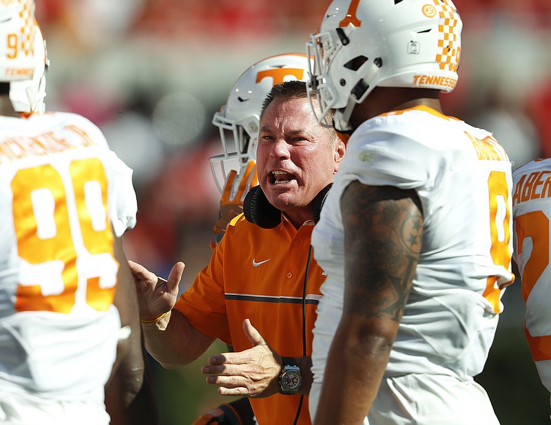 Tennessee head football coach Butch Jones, center, says too many parents prepare the path for their child and not their child for the path.