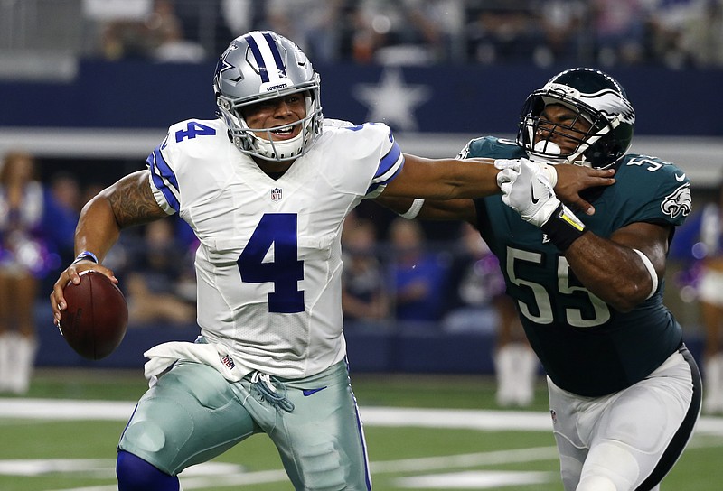 
              Dallas Cowboys quarterback Dak Prescott (4) fights off pressure from Philadelphia Eagles defensive end Brandon Graham (55) before throwing a pass in the first half of an NFL football game, Sunday, Oct. 30, 2016, in Arlington, Texas. (AP Photo/Michael Ainsworth)
            