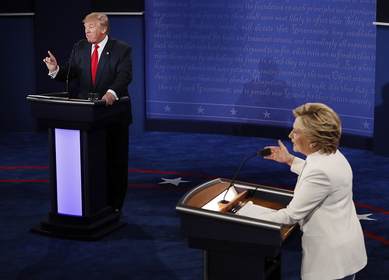 In this Oct. 19, 2016 file photo, Democratic presidential nominee Hillary Clinton and Republican presidential nominee Donald Trump debate during the third presidential debate at UNLV in Las Vegas. (Mark Ralston/Pool via AP, File)
            
