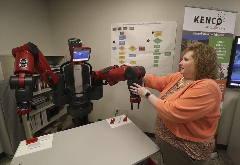 Staff Photo by Dan Henry / Kristi Montgomery, vice president of Kenco's Innovation Labs, speaks about uses for collaborative robots like "Baxter" made by Rethink Robotics while in the labs.