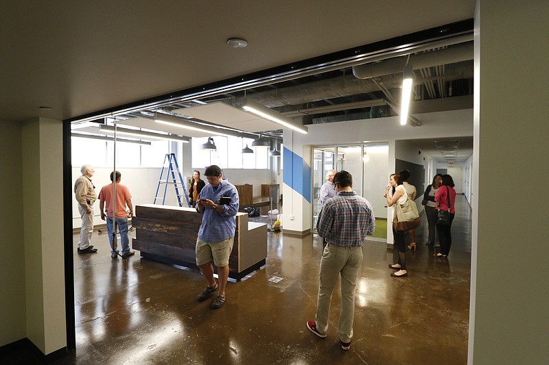 Officials are led on a tour of the Edney Building which will soon become the new hub of the Innovation District housing CoLab and the Enterprise Center.