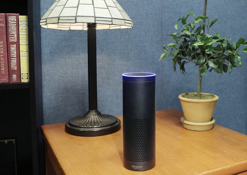 FILE - In this July 29, 2015, file photo, an Amazon Echo sits on a table in New York. The gadget, which listens to you, answers questions and carries out tasks like calling an Uber or turning on your lights, is finding a place in millions of living rooms. However, it will soon face competition from Google and Apple. (AP Photo/Mark Lennihan, File)