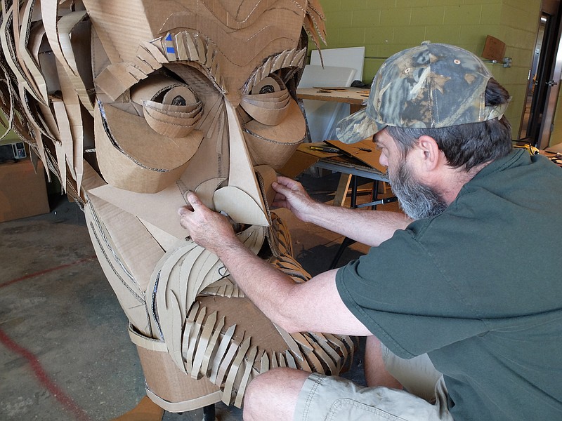 Staff photo by Tim Barber Wayne White constructs the facial skin of Civil War General Patrick Cleburne with corrugated cardboard midday Tuesday in the studio on Rossville Ave. The oversize puppets were part of Glass Street Live parade to commemorate the Centennial of the National Park Service. Work continues on new puppets and art pieces at Wayne-O-Rama on Rossvile Avenue.