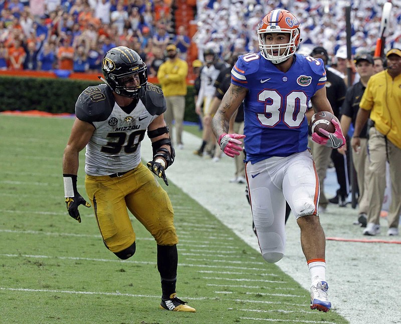 Missouri linebacker and leading tackler Michael Scherer, shown here giving chase to Florida tight end Deandre Goolsby on Oct. 15, has been lost for the season with an ACL injury. The Tigers have allowed 500 or more yards a school-record four straight times.