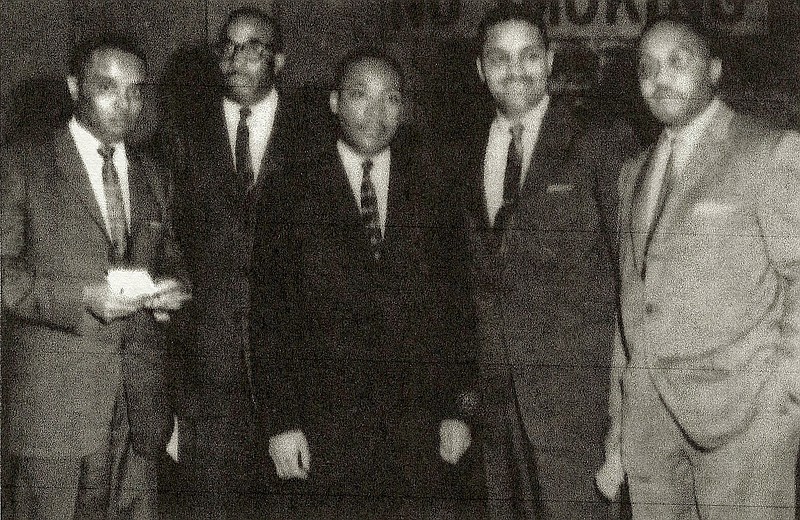 Dr. Horace Traylor (second from right) is seen in this historic photo from a mass meeting here at the Memorial Auditoriam on December 31, 1963.  Also in the from photo, from left are, Dr. Major Jones of Stanley Memorial Methodist Church, Rev. Dogan Williams of Wiley Memorial Methodist Church, Dr. Martin Luther King Jr., Dr. Traylor President of the Council for Cooperative Action, and James R. Mapp of the NAACP.  