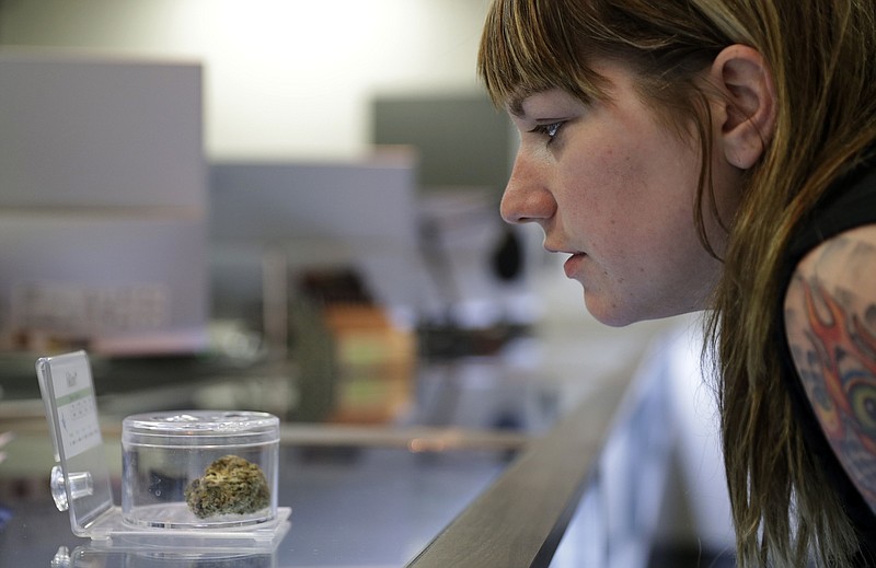 
              In this, Oct. 27, 2016, photo, Rachael Torricelli looks at marijuana for sale at Blum in Las Vegas. Las Vegas could soon add recreational marijuana to its list of vices if Nevada approves a Nov. 8 referendum on cannabis. Supporters see pot as a fitting alternative for tourists tired of $15 cocktails and hangovers. But weed proponents will have to win over closely divided voters and a risk-averse gambling industry. (AP Photo/John Locher)
            