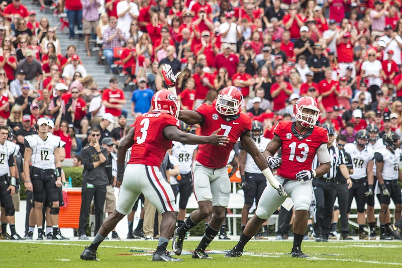 Georgia defenders Roquan Smith (3), Lorenzo Carter (7) and Jonathan Ledbetter (13) celebrate a tackle during last month's home loss to Vanderbilt. The Bulldogs insist they can still have fun amid a disappointing 4-4 season.
