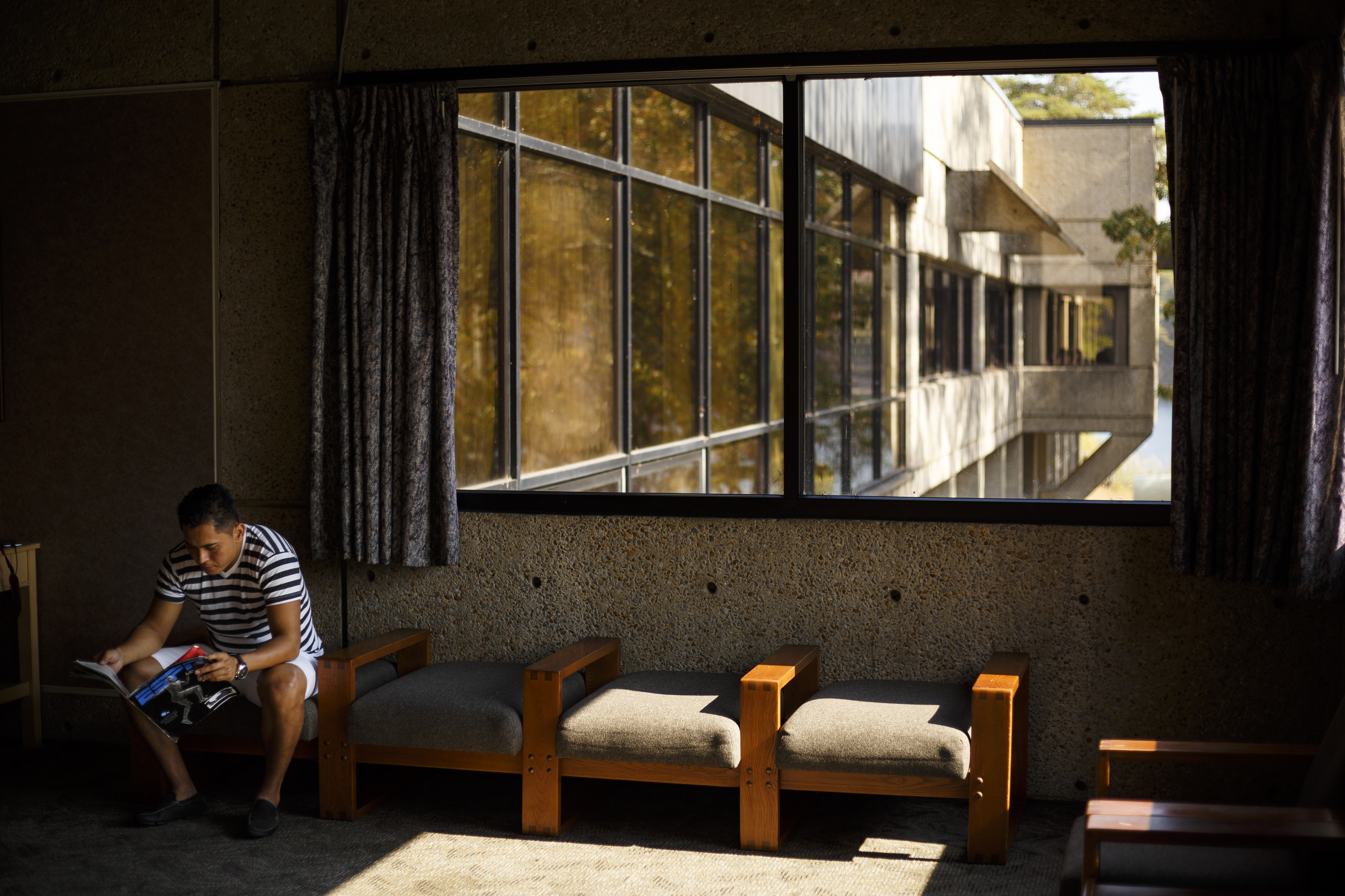 Anibal Bonilla reads a magazine in the park inn's lobby at Fall Creek Falls State Park on Wednesday, Nov. 2, 2016, in Spencer, Tenn. A plan to demolish the park's existing inn and replace it with a new facility that is privately run has apparently been renewed, and the process would take more than 2 years.