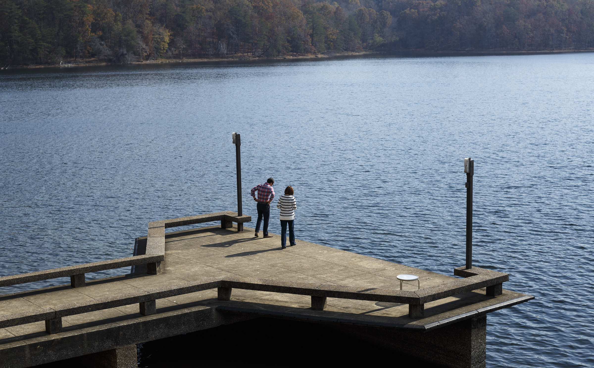 Adam Foote, left, and Susan Robertson, who are staying at the park inn as part of a University of Tennessee Institute for Public Service work retreat, stand on the inn's dock at Fall Creek Falls State Park on Wednesday, Nov. 2, 2016, in Spencer, Tenn. A plan to demolish the park's existing inn and replace it with a new facility that is privately run has apparently been renewed, and the process would take more than 2 years.