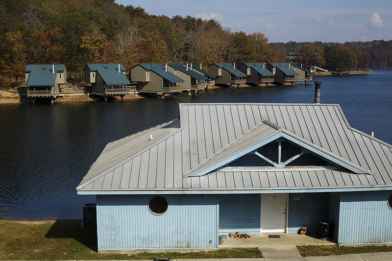 An older guest cabin is seen ahead of recently renovated guest cabins at Fall Creek Falls State Park on Wednesday, Nov. 2, 2016, in Spencer, Tenn. A plan to demolish the park's existing inn and replace it with a new facility that is privately run has apparently been renewed, and the process would take more than 2 years.