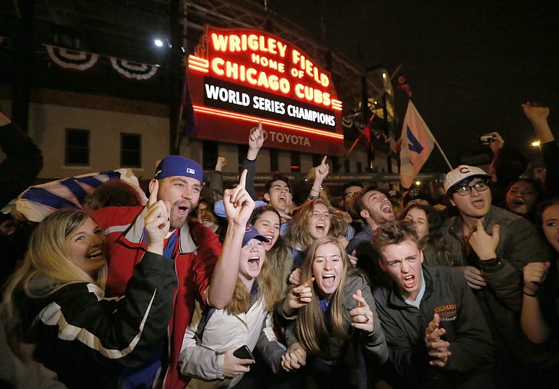 
              Chicago Cubs fans celebrate in front of Wrigley Field in Chicago on Wednesday, Nov. 2, 2016, after the Cubs defeated the Cleveland Indians 8-7 in Game 7 of the baseball World Series in Cleveland. (AP Photo/Charles Rex Arbogast)
            