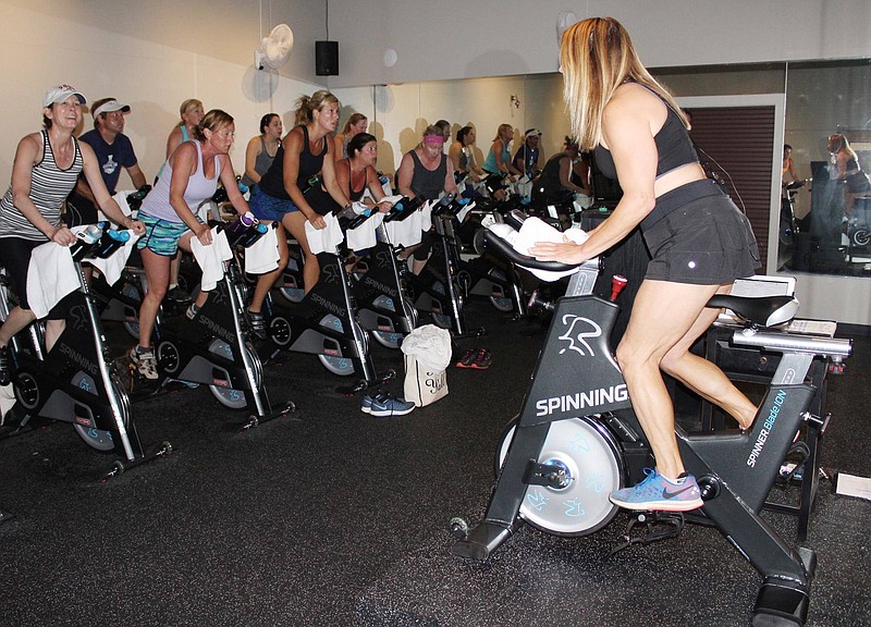 Anna Mercer leads a spinning class using the new Spinner-brand Blade Ion bikes at Sportsbarn.