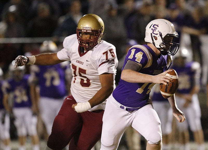 Sequatchie County quarterback Ethan Barker breaks past Howard defender Udarius Strawter during their TSSAA first-round playoff football game at Sequatchie County High School in Dunlap, Tenn.
