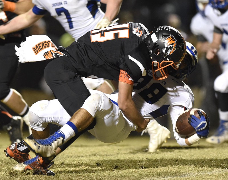 Meigs County's Eli Loden (15) tackles Jackson County's Wesley Punzalan (88).  The Jackson County Blue Devils visited the Meigs County Tigers in the first round of the TSSAA playoff on November 4, 2016.