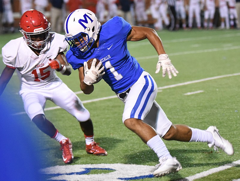 McCallie's Rico Dozier turns upfield as Brentwood's Kenyon Garlington (15) pursues in first quarter action Friday at McCallie.