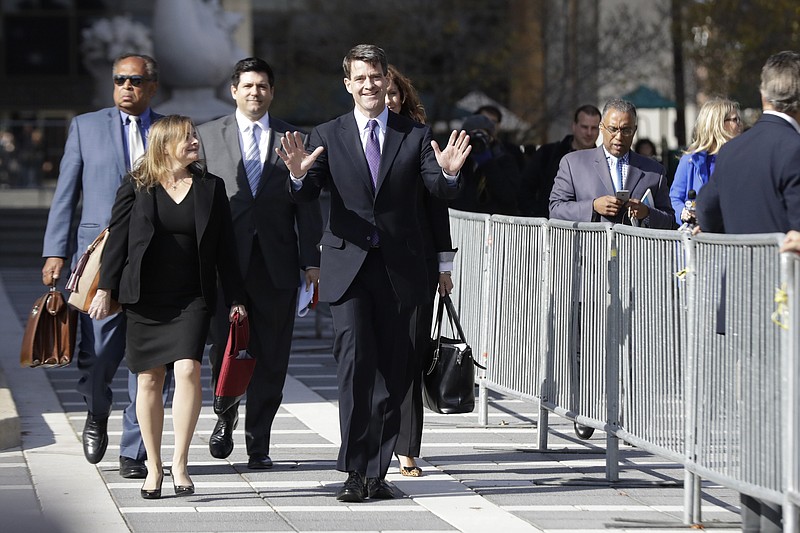 Bill Baroni, center, New Jersey Gov. Chris Christie's former top appointee at the Port Authority of New York and New Jersey, gestures at reporters while leaving Martin Luther King, Jr., Federal Court, after he was found guilty on all counts in the George Washington Bridge traffic trial, Friday, Nov. 4, 2016, in Newark, N.J. 
