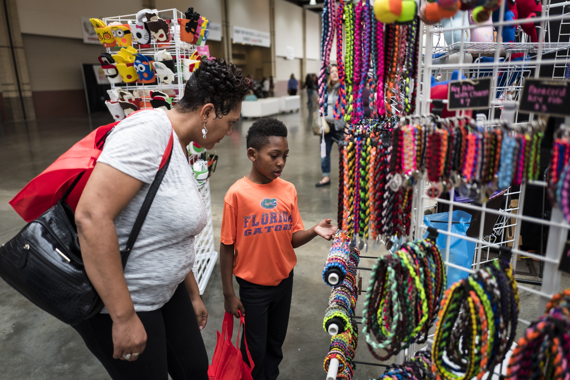 Alycia Miles, left, and her son Avaery Ford shop at the Times Free Press's HoHo Expo at the Chattanooga Convention Center on Saturday, Nov. 5, 2016, in Chattanooga, Tenn. The holiday expo features more than 200 vendors as well as children's entertainment and continues Sunday.