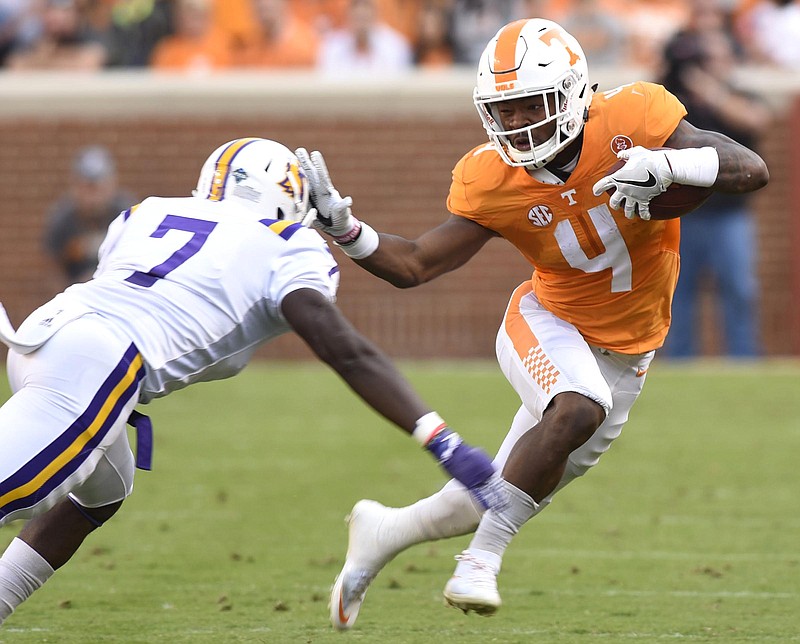 Tennessee's John Kelly (4) stiff arms Tennessee Tech's Josh Poplar (7).  The Tennessee Tech Golden Eagles visited the Tennessee Volunteers in NCAA football action at Neyland Stadium in Knoxville on November 5, 2016.