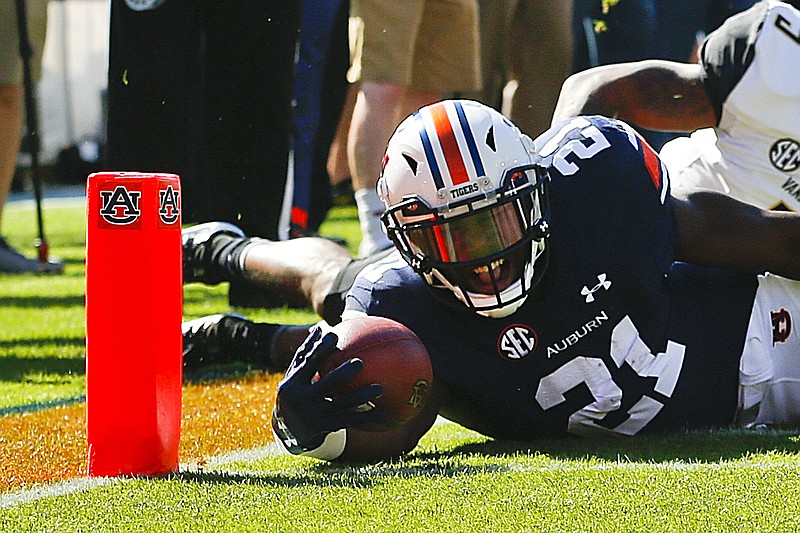 Auburn running back Kerryon Johnson dives over the goal line for a touchdown against Vanderbilt during the first half of an NCAA college football game, Saturday, Nov. 5, 2016, in Auburn, Ala. (AP Photo/Brynn Anderson)