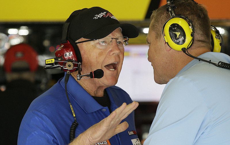 Sprint Cup Series team owner Joe Gibbs, left, talks in the garage during NASCAR auto racing practice at Texas Motor Speedway in Fort Worth, Texas, Saturday, Nov. 5, 2016. All four Joe Gibbs Racing drivers are still in contention, with only three spots available for the title-deciding race in NASCAR's Chase for the Sprint Cup. (AP Photo/LM Otero)